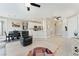 Open concept living room and dining area with tile flooring, white trim, and stainless steel appliances at 9130 Haddington Ln, Las Vegas, NV 89145