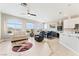 Open-concept living room with tile flooring, large windows, ceiling fan, and contemporary decor at 9130 Haddington Ln, Las Vegas, NV 89145