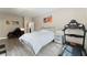 Bright bedroom with a bed, treadmill, desk, and wood-look laminate flooring at 9130 Haddington Ln, Las Vegas, NV 89145