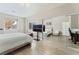 Bright main bedroom with two windows, mirrored closet, and light wood laminate flooring at 9130 Haddington Ln, Las Vegas, NV 89145