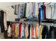 Well-organized walk-in closet with hanging clothes on metal shelving in the main bedroom suite at 9130 Haddington Ln, Las Vegas, NV 89145