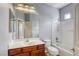 Clean bathroom with a bathtub and shower, vanity, and large mirror at 9432 Victory Garden Ave, Las Vegas, NV 89149