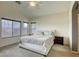 Bright bedroom with a large bed, carpet flooring and windows providing natural light at 9432 Victory Garden Ave, Las Vegas, NV 89149