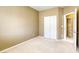 This bedroom features neutral walls, carpet, and a closet with sliding doors at 9432 Victory Garden Ave, Las Vegas, NV 89149