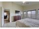 Inviting bedroom featuring a large bed, carpet flooring, and a TV at 9432 Victory Garden Ave, Las Vegas, NV 89149