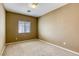 This bedroom features neutral walls, carpet, and a window allowing natural light at 9432 Victory Garden Ave, Las Vegas, NV 89149