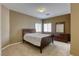 Comfortable bedroom featuring a queen-size bed and dresser with mirror at 9432 Victory Garden Ave, Las Vegas, NV 89149