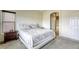 Comfortable bedroom with a large bed, carpet flooring, and ensuite bathroom access at 9432 Victory Garden Ave, Las Vegas, NV 89149