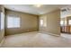 Bright bonus room with neutral carpet and archway to second living area at 9432 Victory Garden Ave, Las Vegas, NV 89149