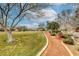 This neighborhood features a community park with walking paths, grass, and mature trees at 9432 Victory Garden Ave, Las Vegas, NV 89149