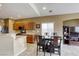 Open-concept kitchen and dining area with a breakfast bar and tile flooring at 9432 Victory Garden Ave, Las Vegas, NV 89149
