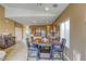 Cozy dining area with a wooden table, seating for six, and a bar for entertaining guests at 9432 Victory Garden Ave, Las Vegas, NV 89149