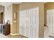 Hallway featuring closet with bi-fold doors, wall decor, and access to other rooms at 9432 Victory Garden Ave, Las Vegas, NV 89149
