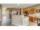 Open kitchen with stainless steel appliances, a breakfast bar, and tile flooring at 9432 Victory Garden Ave, Las Vegas, NV 89149