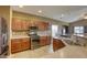 Bright kitchen featuring stainless steel appliances, wooden cabinetry, and a breakfast bar at 9432 Victory Garden Ave, Las Vegas, NV 89149