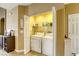 Convenient laundry room featuring a side-by-side washer and dryer unit and shelves at 9432 Victory Garden Ave, Las Vegas, NV 89149