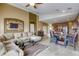Open concept floor plan with living room adjacent to the eat-in kitchen with granite countertops at 9432 Victory Garden Ave, Las Vegas, NV 89149