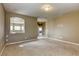 Open living area with neutral carpet, recessed lighting, and archway to hallway at 9432 Victory Garden Ave, Las Vegas, NV 89149