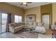 Inviting living room with comfortable seating, neutral tones, and lots of natural light at 9432 Victory Garden Ave, Las Vegas, NV 89149
