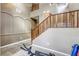 Carpeted staircase with wood railings, high ceilings, and landing area with exercise equipment at 9432 Victory Garden Ave, Las Vegas, NV 89149