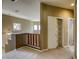 Upstairs landing leading to a closet with shelving and natural light at 9432 Victory Garden Ave, Las Vegas, NV 89149
