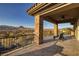 Covered balcony featuring stone columns, tile flooring, and views of Lake Las Vegas at 10 Via Potenza Ct, Henderson, NV 89011