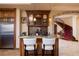 Bar area with wine storage and seating that leads to the staircase at 10 Via Potenza Ct, Henderson, NV 89011
