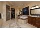 This virtual bathroom includes a soaking tub, vanity, glass shower, and decorative rug at 10 Via Potenza Ct, Henderson, NV 89011