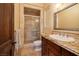 Bathroom with a vanity, granite countertop, sliding glass door shower, and wood door at 10 Via Potenza Ct, Henderson, NV 89011