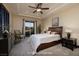 Bedroom with a comfortable bed, a dresser, and a view of the outdoors at 10 Via Potenza Ct, Henderson, NV 89011