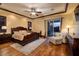 View of a staged bedroom, with a decorative tray ceiling and stylish furniture at 10 Via Potenza Ct, Henderson, NV 89011