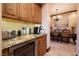 Butler's pantry with custom wood cabinets, granite countertops, and wine fridge at 10 Via Potenza Ct, Henderson, NV 89011