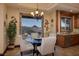 Charming dining area with a glass table, scenic views, and natural light at 10 Via Potenza Ct, Henderson, NV 89011