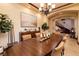 Formal dining room features elegant chandelier, dining table, and sideboard with arched entryways at 10 Via Potenza Ct, Henderson, NV 89011