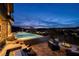 Relaxing backyard oasis with a sparkling pool, luxurious hot tub, and cozy fire pit creating an entertainer's dream at 10 Via Potenza Ct, Henderson, NV 89011