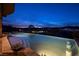 Stunning infinity pool with city views, built-in bar stools, and elegant landscaping creating a serene oasis at 10 Via Potenza Ct, Henderson, NV 89011