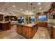 Spacious kitchen features an island, stainless steel appliances, and an adjacent living area with large windows at 10 Via Potenza Ct, Henderson, NV 89011