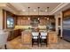 Gourmet kitchen with stainless steel appliances, a large island, and custom cabinets at 10 Via Potenza Ct, Henderson, NV 89011