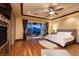 Main bedroom features beautiful hardwood flooring, a ceiling fan, and a fireplace at 10 Via Potenza Ct, Henderson, NV 89011
