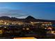 Picturesque view of the city at night with distant mountains and bright lights over the neighboring area at 10 Via Potenza Ct, Henderson, NV 89011