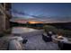 Relaxing outdoor area with fire pit, comfortable seating, built-in grill, and breathtaking sunset views at 10 Via Potenza Ct, Henderson, NV 89011