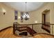 View of a curved staircase with wood floors, iron railing, and a chandelier at 10 Via Potenza Ct, Henderson, NV 89011