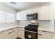 Updated kitchen with white cabinets, stainless steel appliances, and sleek countertops at 1011 Pearl Marble Ave, North Las Vegas, NV 89081