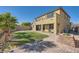 Spacious backyard features lush green grass, mature palm trees, and brick accents at 10173 Skye Saddle Ave, Las Vegas, NV 89166
