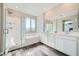 Bright bathroom with a walk-in shower, separate tub, and dual sink vanity at 10173 Skye Saddle Ave, Las Vegas, NV 89166