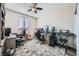 Functional bedroom designed as office with desks, natural light, guitar, keyboard, and ceiling fan at 10173 Skye Saddle Ave, Las Vegas, NV 89166