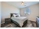 Comfortable bedroom features wood-look flooring, a ceiling fan, and a window with blinds at 10173 Skye Saddle Ave, Las Vegas, NV 89166