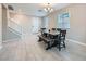 Bright dining area with tiled flooring, a modern chandelier, and stairs to the upper level at 10173 Skye Saddle Ave, Las Vegas, NV 89166