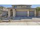 Two-story home showing a three-car garage with a brick-paved driveway and tiled roof at 10173 Skye Saddle Ave, Las Vegas, NV 89166