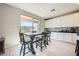 Bright eat-in kitchen with white cabinets, tile backsplash, and a sliding glass door at 10173 Skye Saddle Ave, Las Vegas, NV 89166